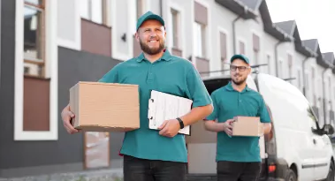 Movers holding cardboard boxes